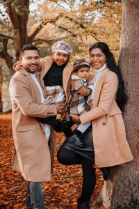 Mum and dad holding their two girls having fun and laughing