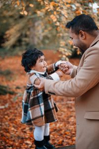 Dad and daughter looking at each other laughing