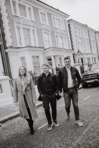 Black and White lifestyle image of 3 people crossing road in Chelsea