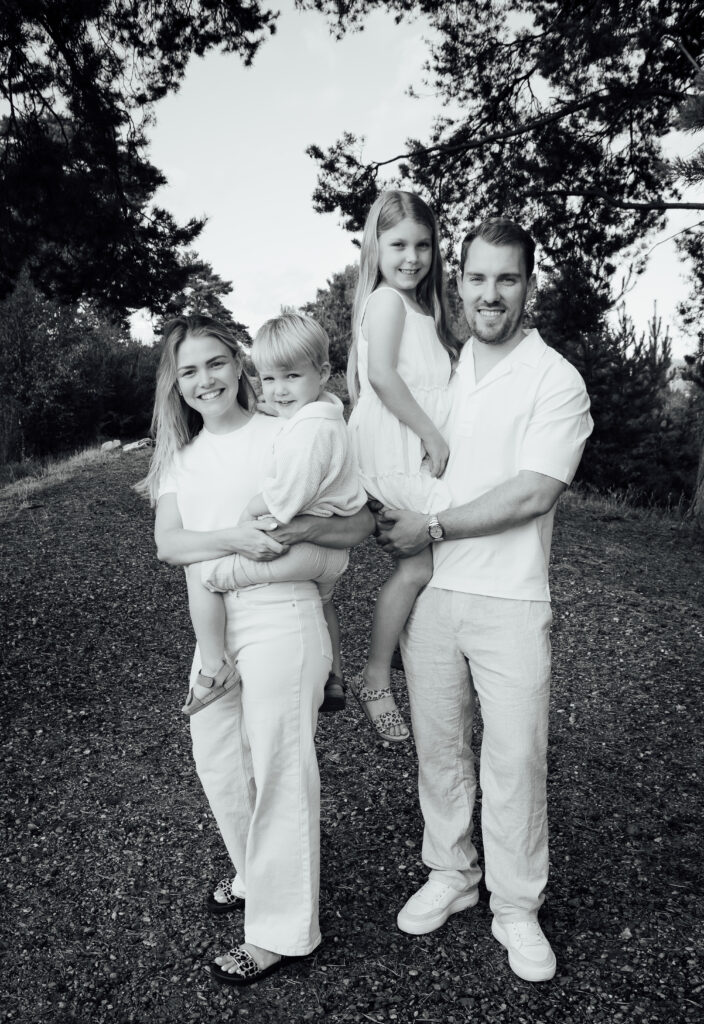 Black and white image of a family of four having fun