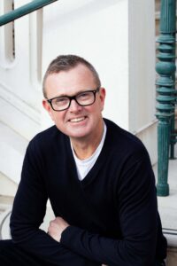 Man sitting on steps smiling at the camera