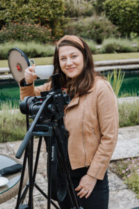 Fun behind the scenes shot of Katy the videographer smiling taking a moment with a cup of tea.