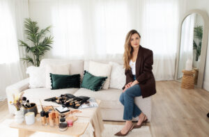 Image of a Female make-up Artist sitting on the edge of a sofa