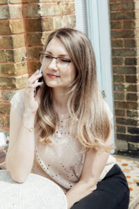 Outside image of a lady sitting on her phone